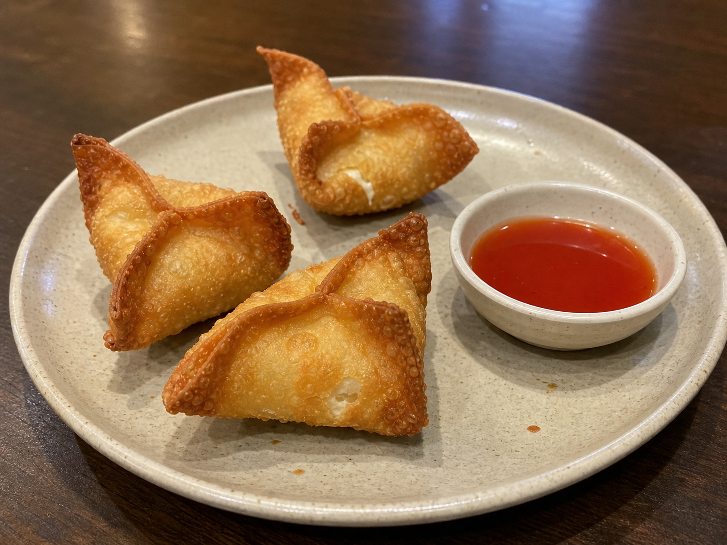 Crisp folded crab rangoon wontons served with dipping sauce