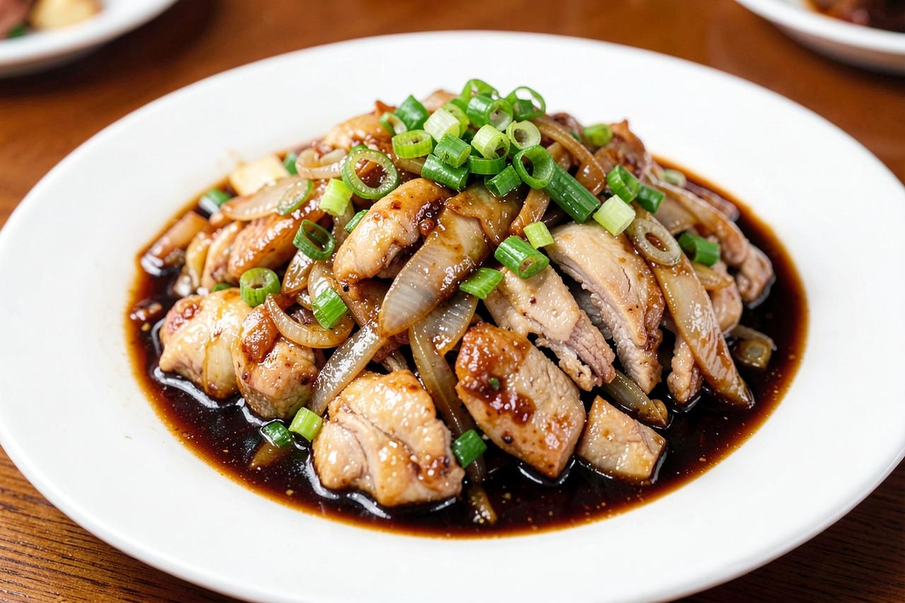 Mongolian chicken with scallions and onions in a glossy savory sauce