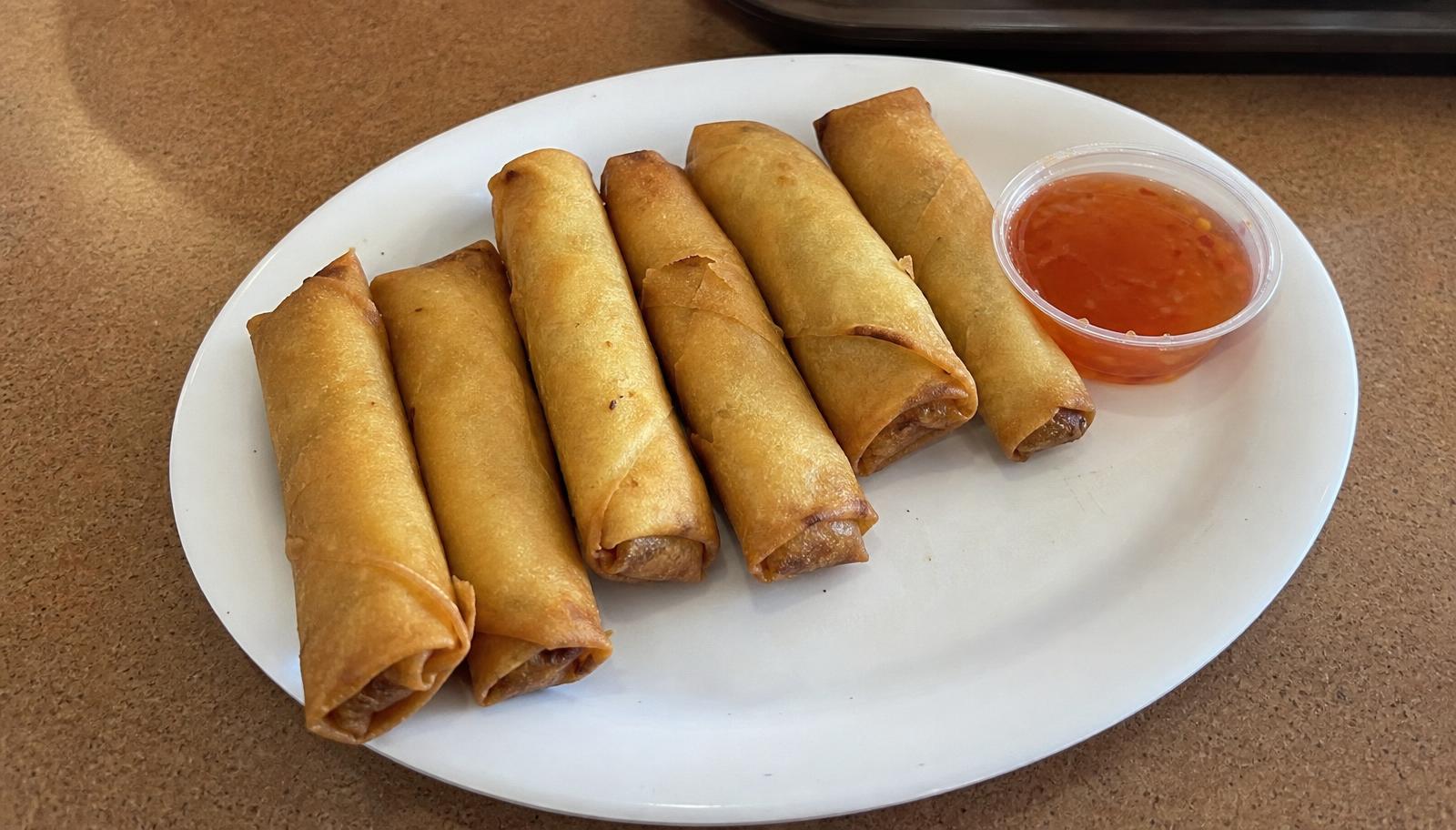 Crispy golden spring rolls served with sweet chili dipping sauce